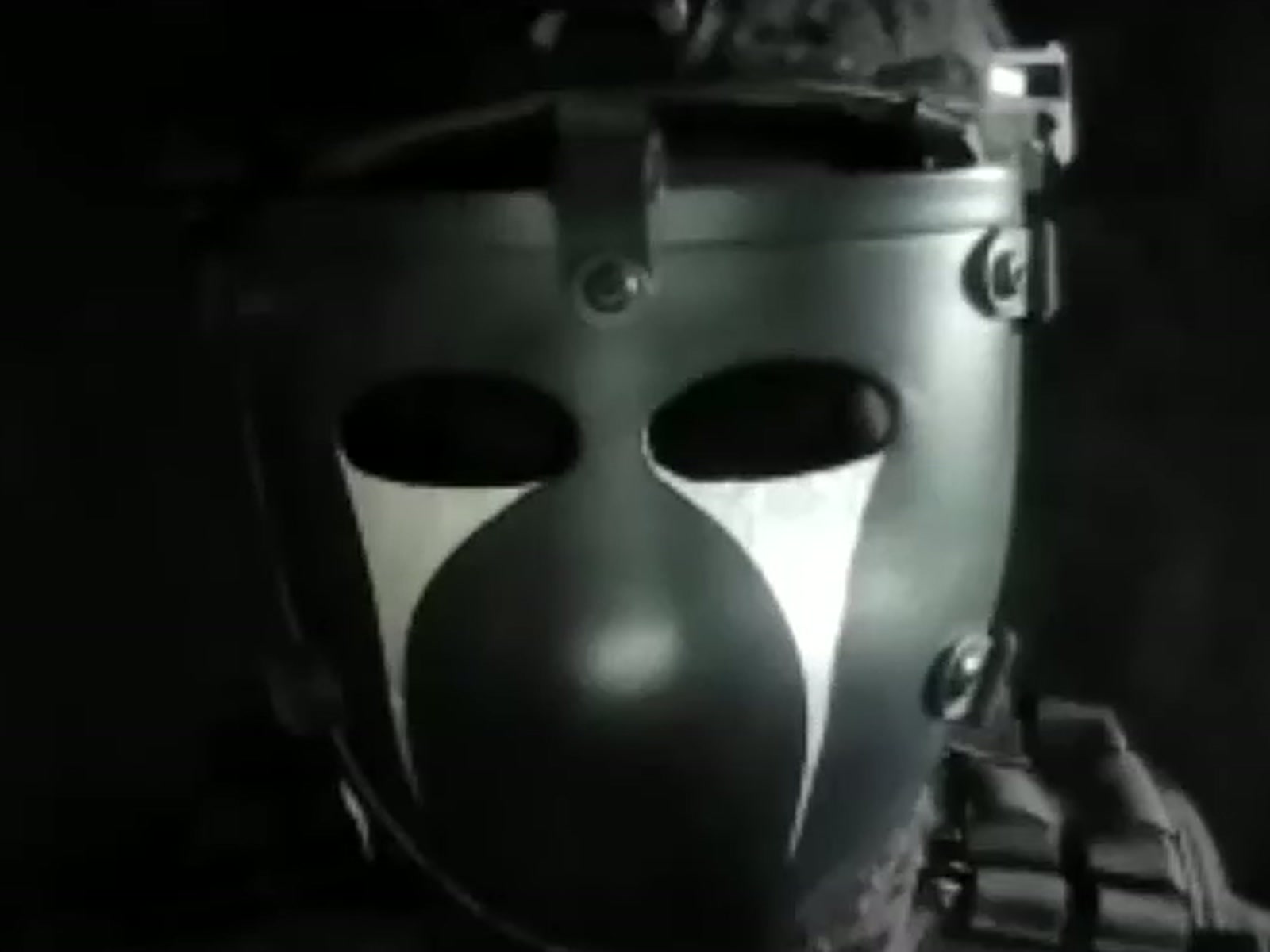One of the PoliePals, masked, a frame from their own film